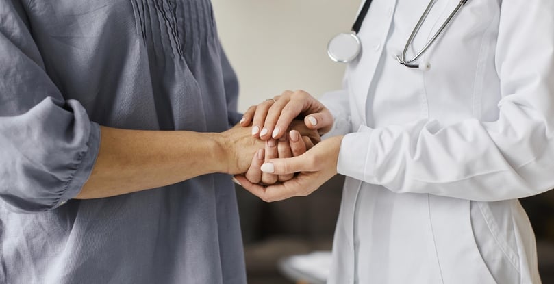 covid-recovery-center-female-doctor-holding-older-patient-s-hands